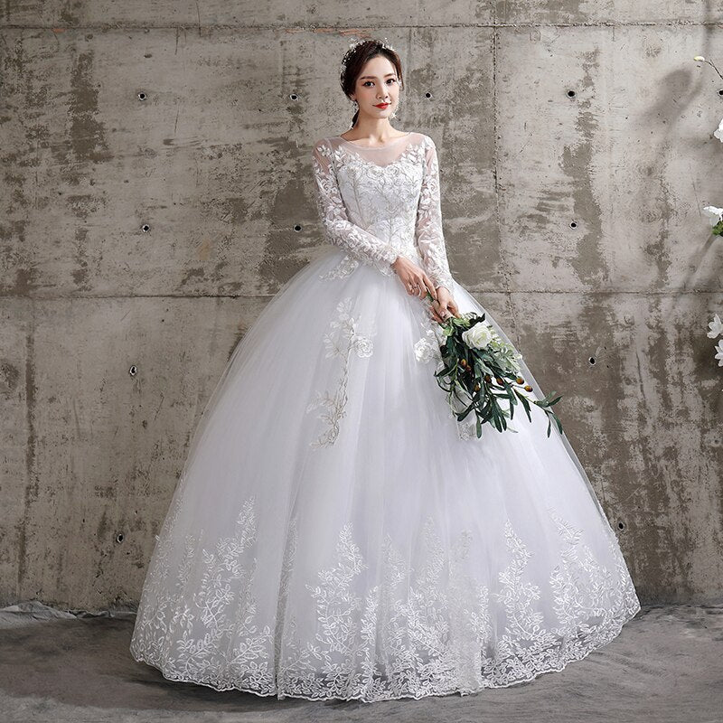 Elegant long sleeve lace wedding dress by The Clothing Company Sydney featuring a luxurious plus size ball gown style.