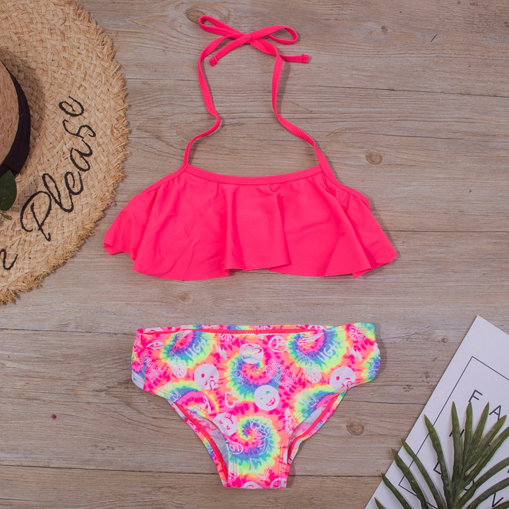 Kids swimwear set by The Clothing Company Sydney, vibrant printed girls' bikini and bandage swimsuit for ages 5-14.
