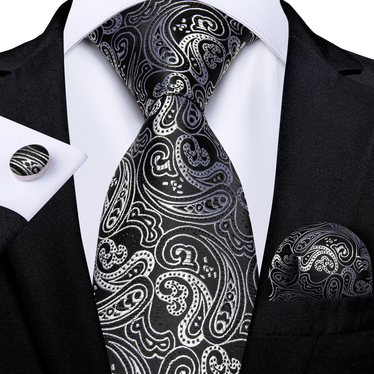 Men's gray paisley silk tie set with wedding tie, pocket square, and cufflinks featuring intricate paisley pattern.