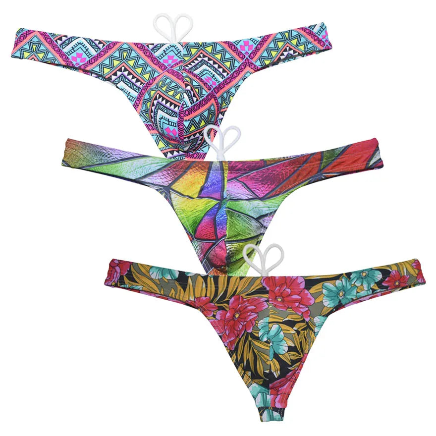 Men's bikini swim thong by The Clothing Company Sydney, printed T-back swimsuit with smooth fabric, suitable for beach and surfing activities.