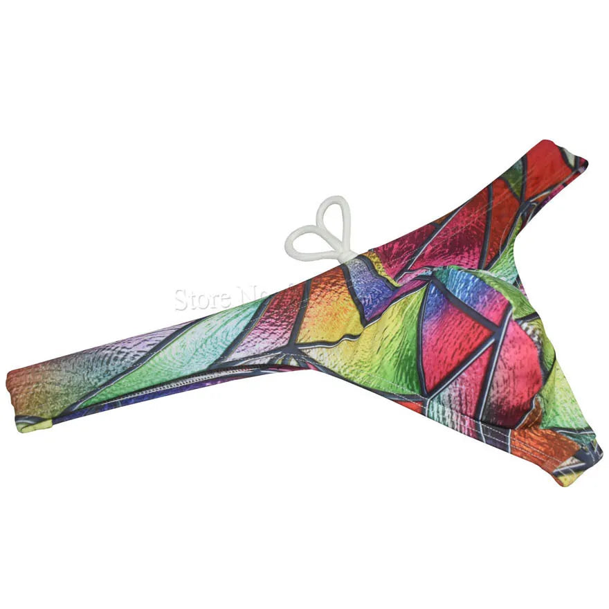 Men's printed bikini swim thong from The Clothing Company Sydney, featuring T-back design and smooth, minimal beachwear for surfing.