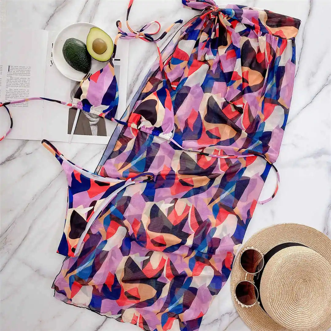 Three-piece women's swimsuit by The Clothing Company Sydney featuring a printed halter bikini, sarong, and swimwear for summer.