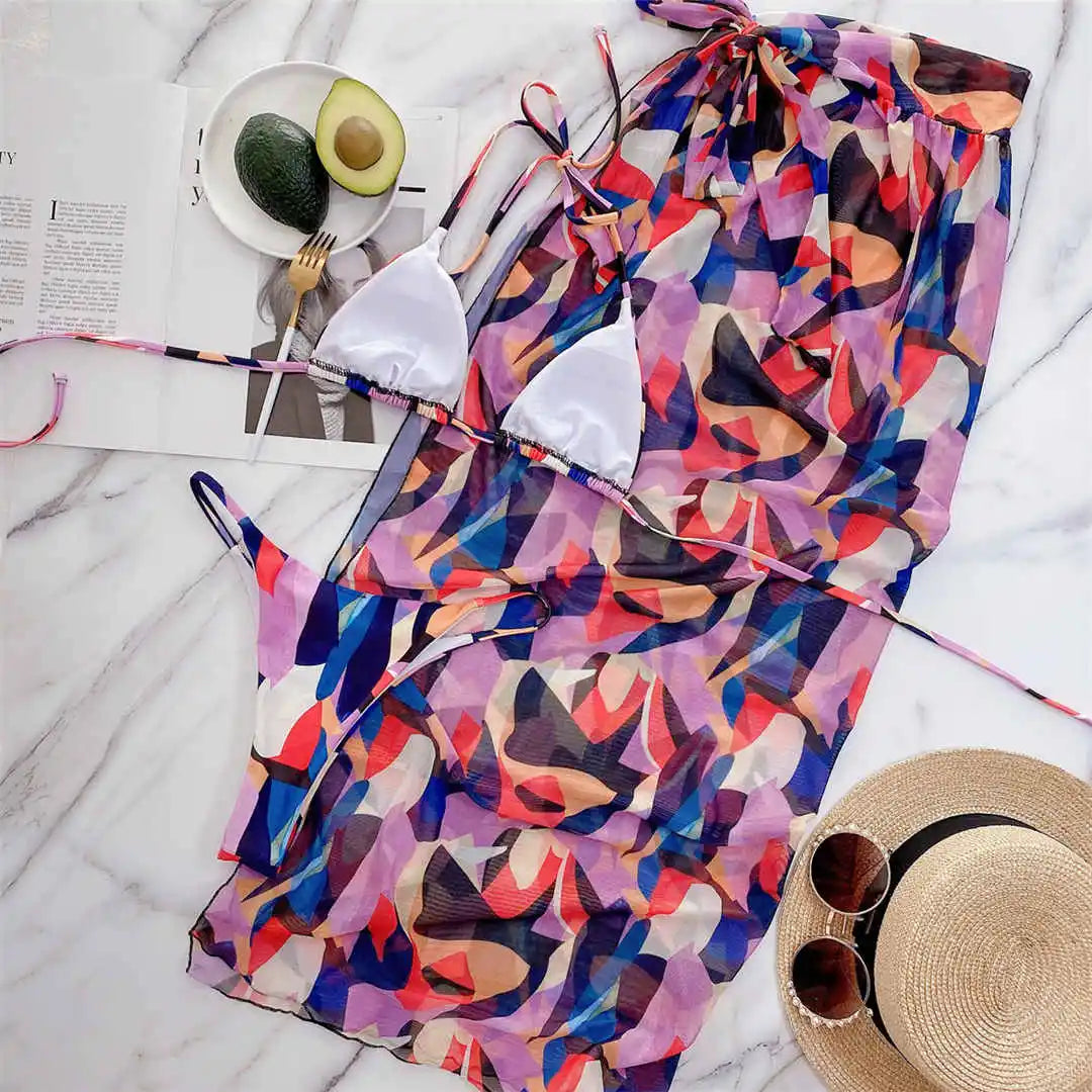 Three-piece women’s halter bikini set with printed cube design, including sarong and bathing suit from The Clothing Company Sydney.