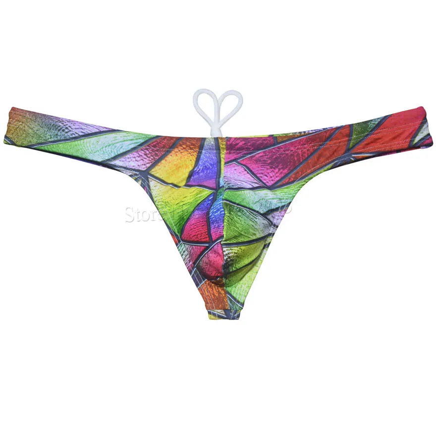 Men's bikini swim thong by The Clothing Company Sydney, printed T-back swimsuit with smooth fabric for beach and surfing activities.