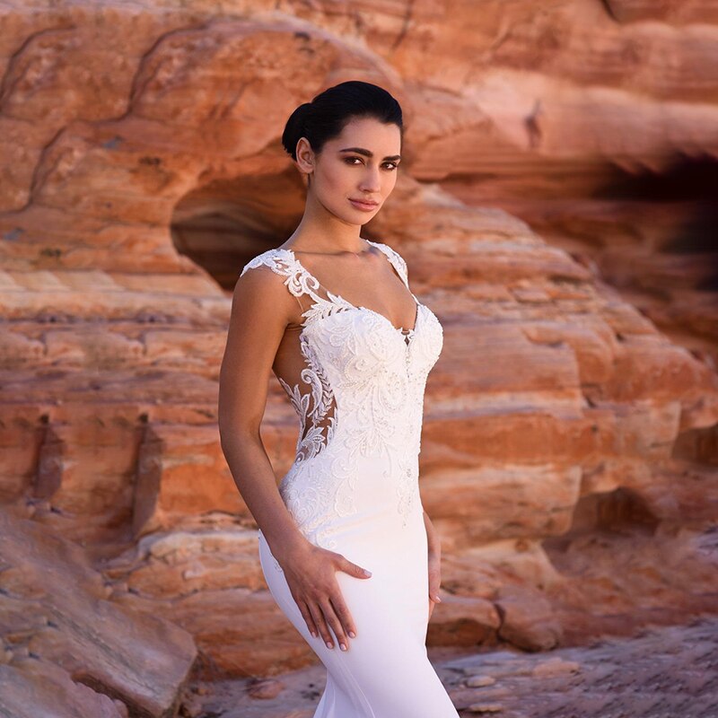 Satin mermaid wedding dress by The Clothing Company Sydney with beaded details, sleeveless design, V-neck, and long train.