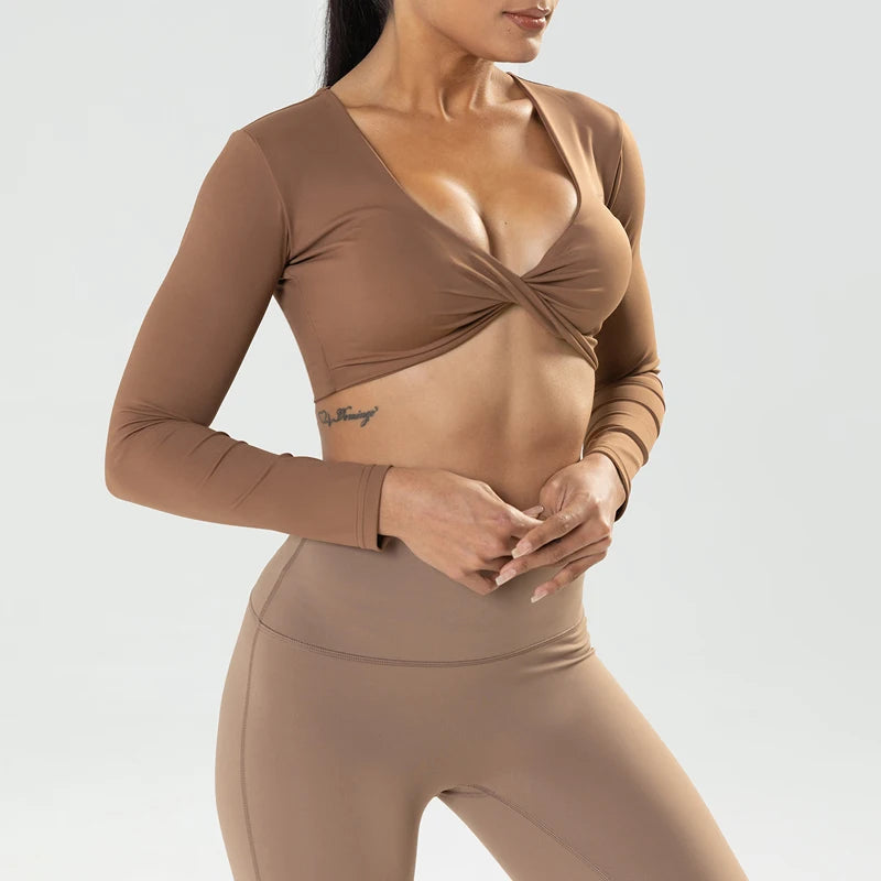 The Clothing Company Sydney long sleeve gym crop top with twist design, deep V neckline, quick-dry fabric, padded, ideal for yoga and fitness.