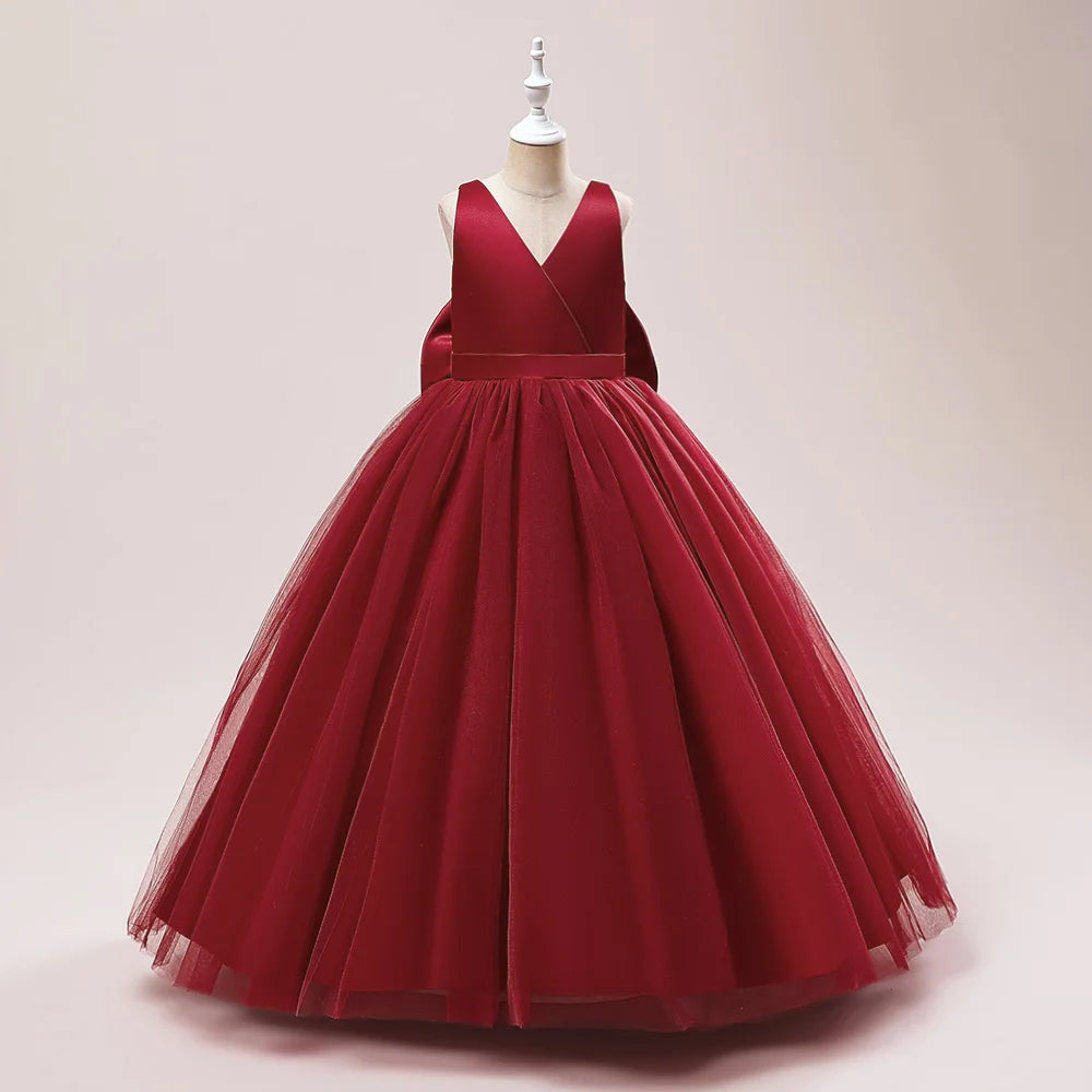 Girls long white bridesmaid and prom gown with a big bow, suitable for wedding, party, or formal evening events.