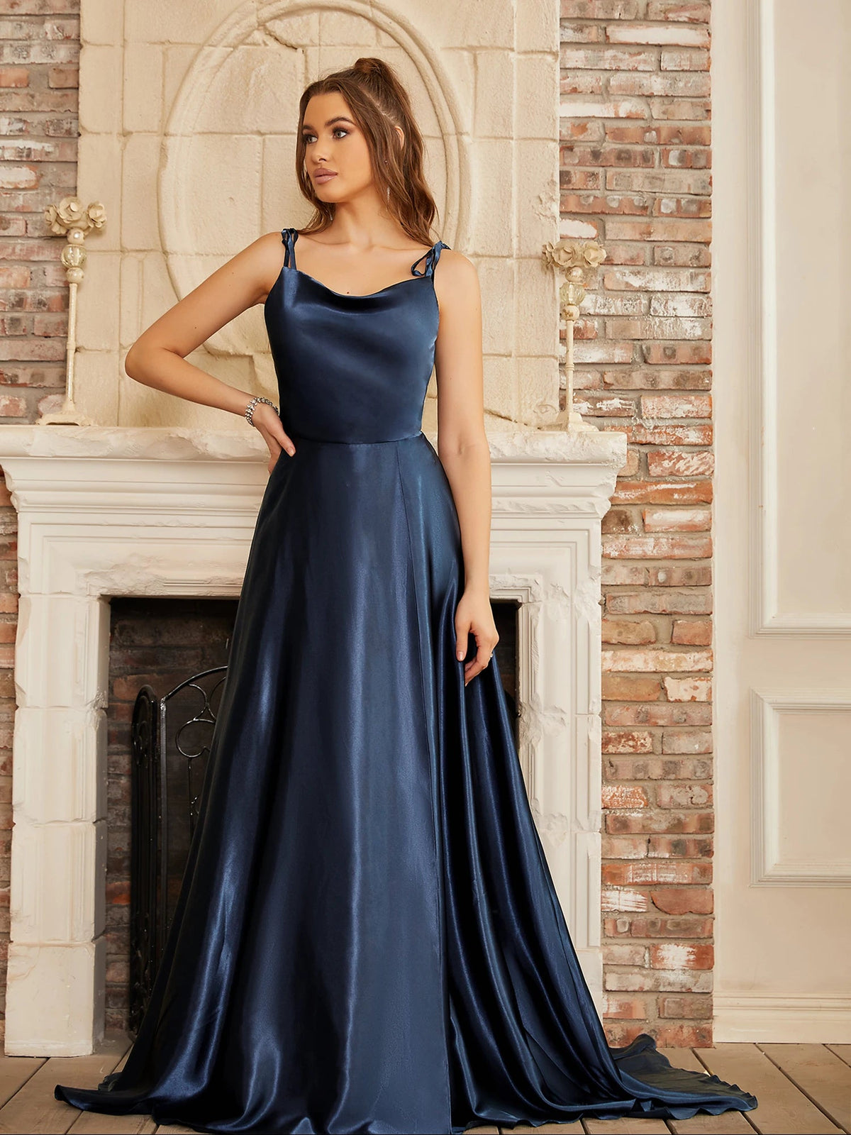 Mint green satin bridesmaid gown with side slit, backless design, spaghetti straps, perfect for summer evening weddings.