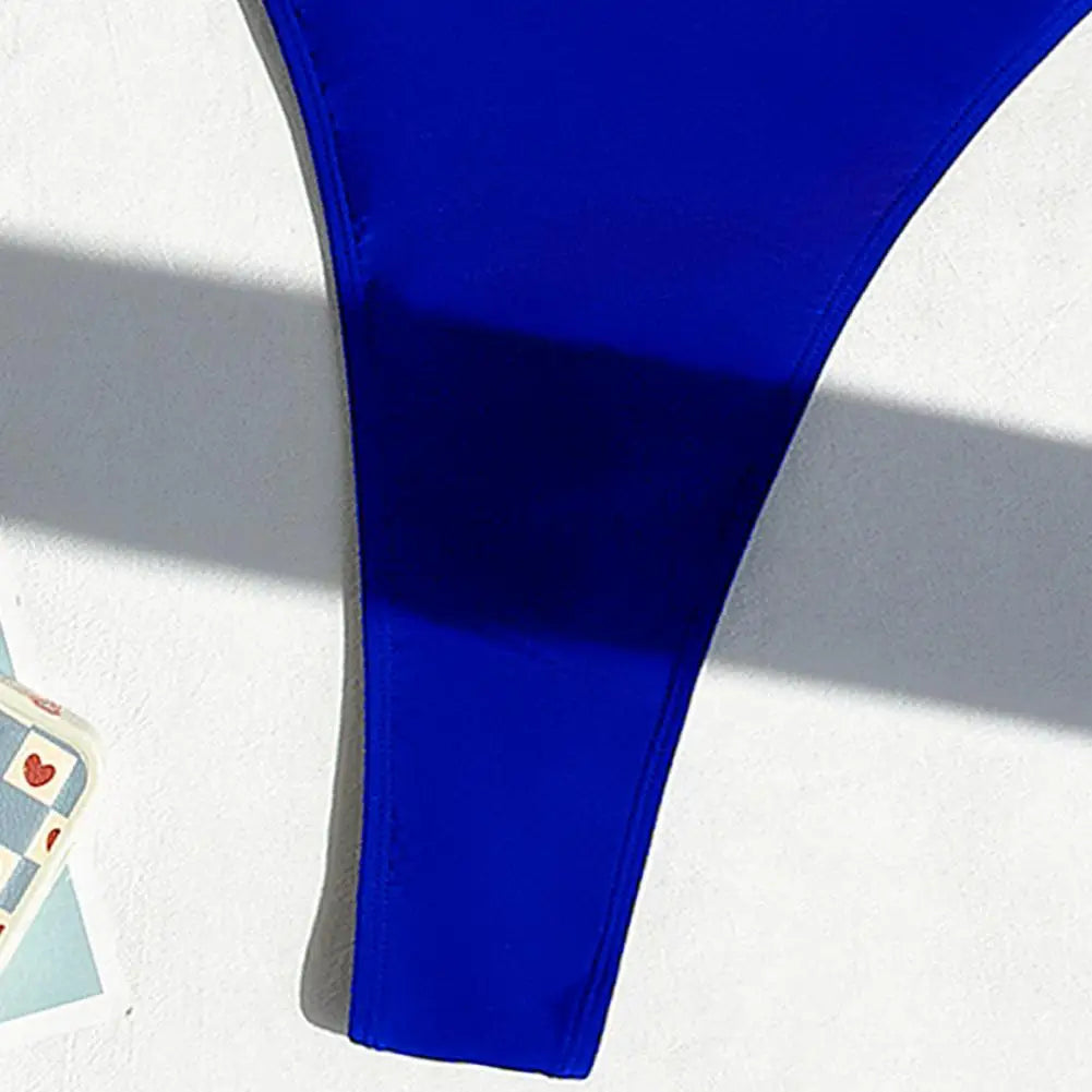 Backless micro thong one-piece swimsuit for women by The Clothing Company Sydney, showcasing a sleek, minimal design with a backless style.