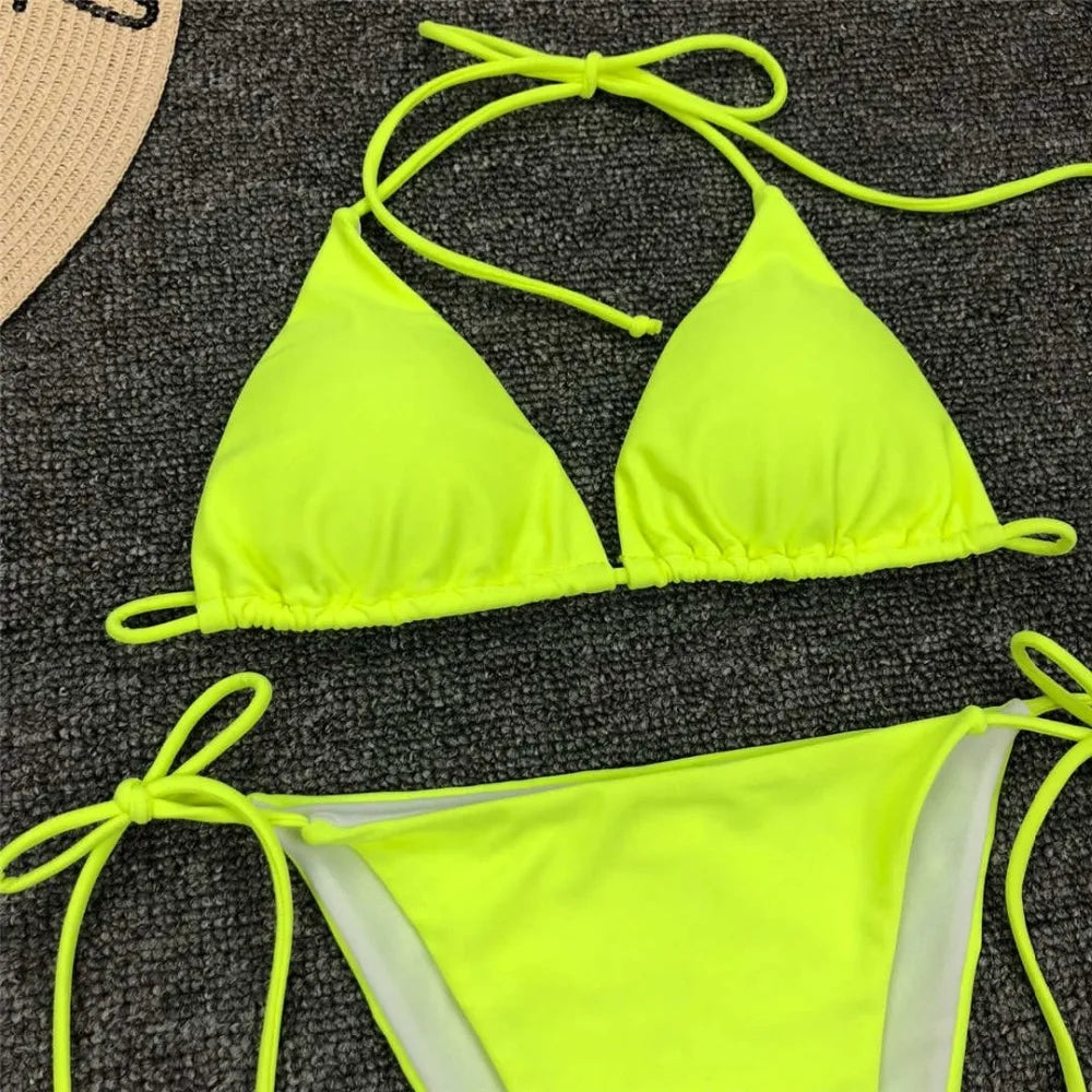 Neon pink Brazilian bikini set for women, halter style two-piece swimwear from The Clothing Company Sydney, featuring a stylish bathing suit.