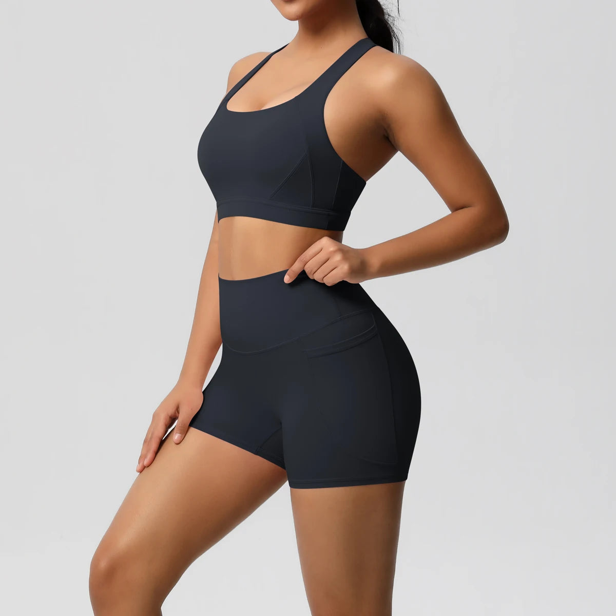 Two-piece women's sportswear yoga set with crossover bra, workout shorts, and gym leggings by The Clothing Company Sydney.