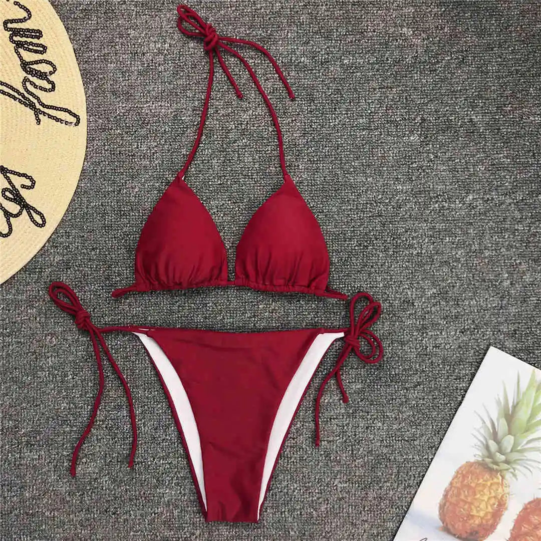 Neon pink Brazilian bikini set for women, halter style two-piece swimsuit with cheeky bottoms, designed by The Clothing Company Sydney.