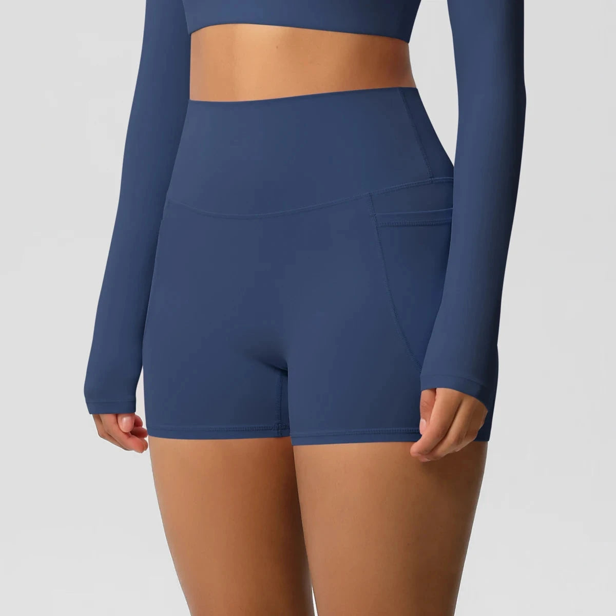 High-waisted bicycle yoga shorts with pockets, quick-drying, breathable fabric, designed for women’s workout and fitness activities.