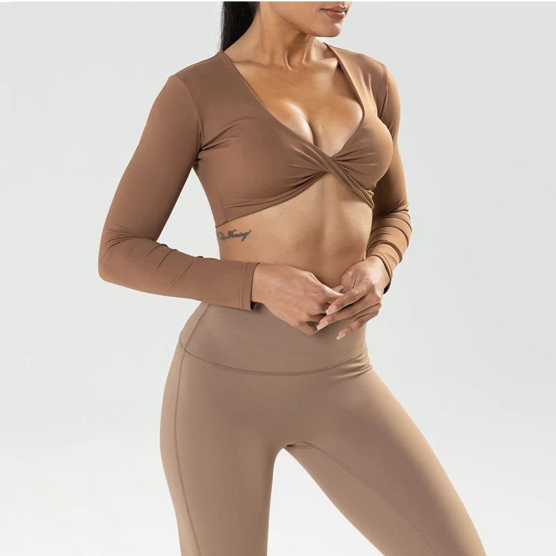 Long sleeve fitness crop top by The Clothing Company Sydney with twist detail, deep V neckline, quick-dry fabric, padded for workout and yoga.