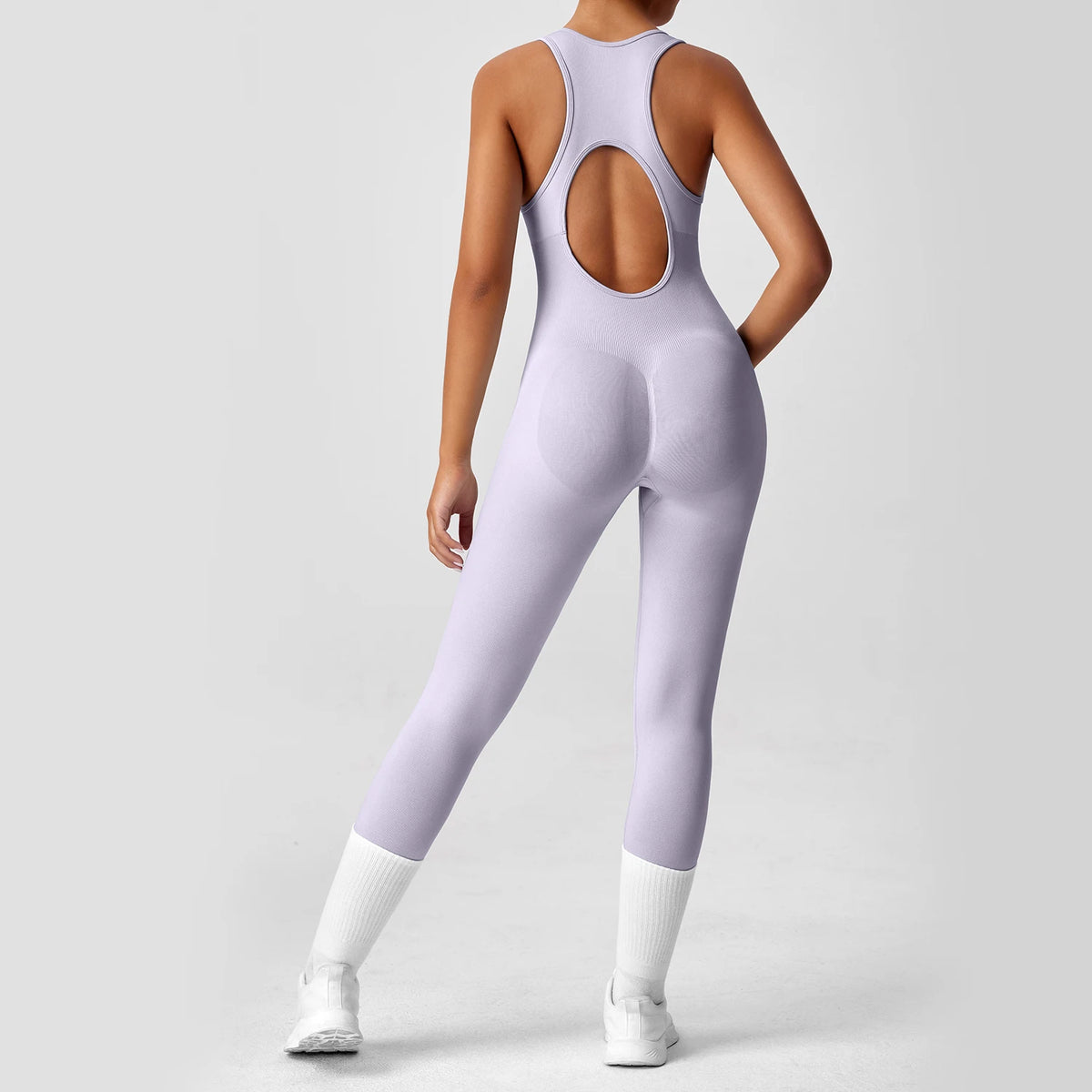 Seamless peach-colored women's yoga bodysuit with V-back, designed for exercise and fitness by The Clothing Company Sydney.