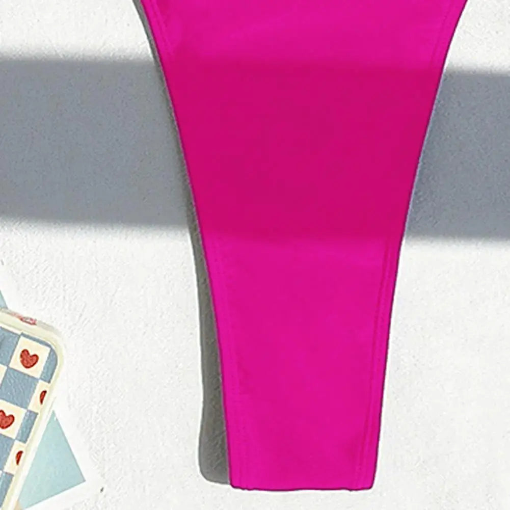 Backless micro thong one-piece swimsuit for women by The Clothing Company Sydney, featuring a sleek design and minimal coverage.
