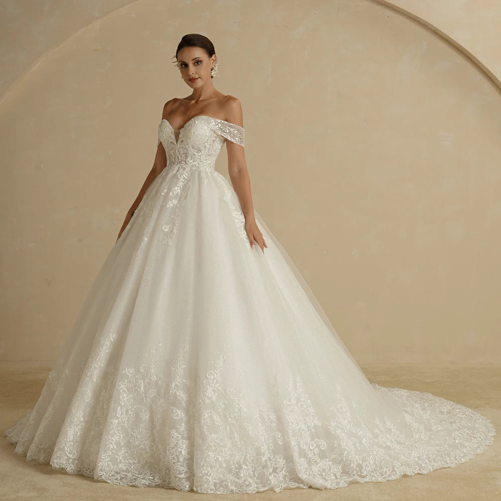 Ivory strapless A-line wedding dress with glitter accents and off-the-shoulder design, designed for brides, by The Clothing Company Sydney.
