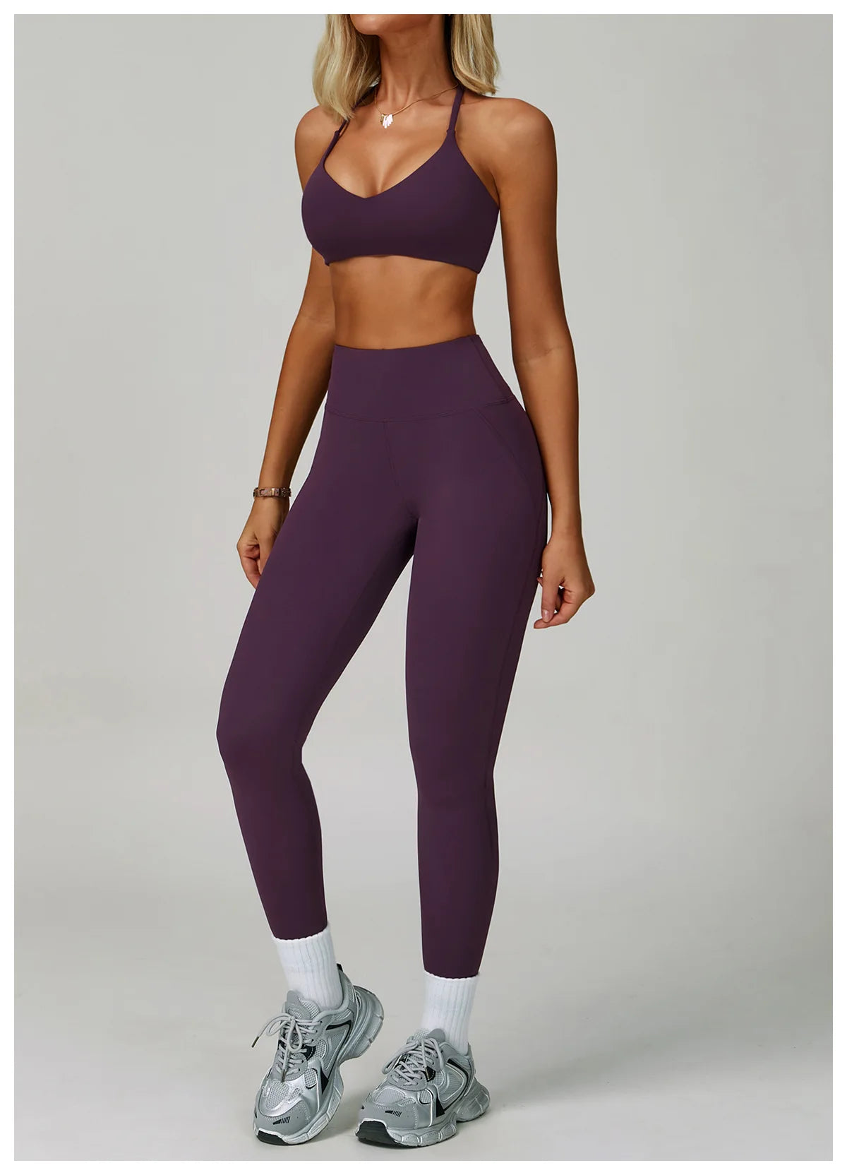 Two-piece women's fitness tracksuit with high-waist leggings and sports bra, ideal for yoga, gym, and workout activities.