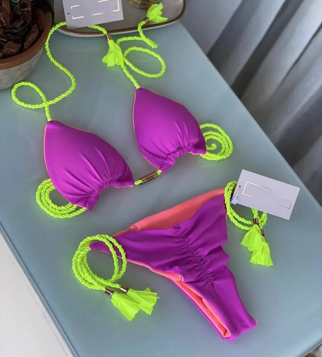 Backless women's bikini swimsuit with rope triangle top, in vibrant colors, featuring stylish swimwear design by The Clothing Company Sydney.