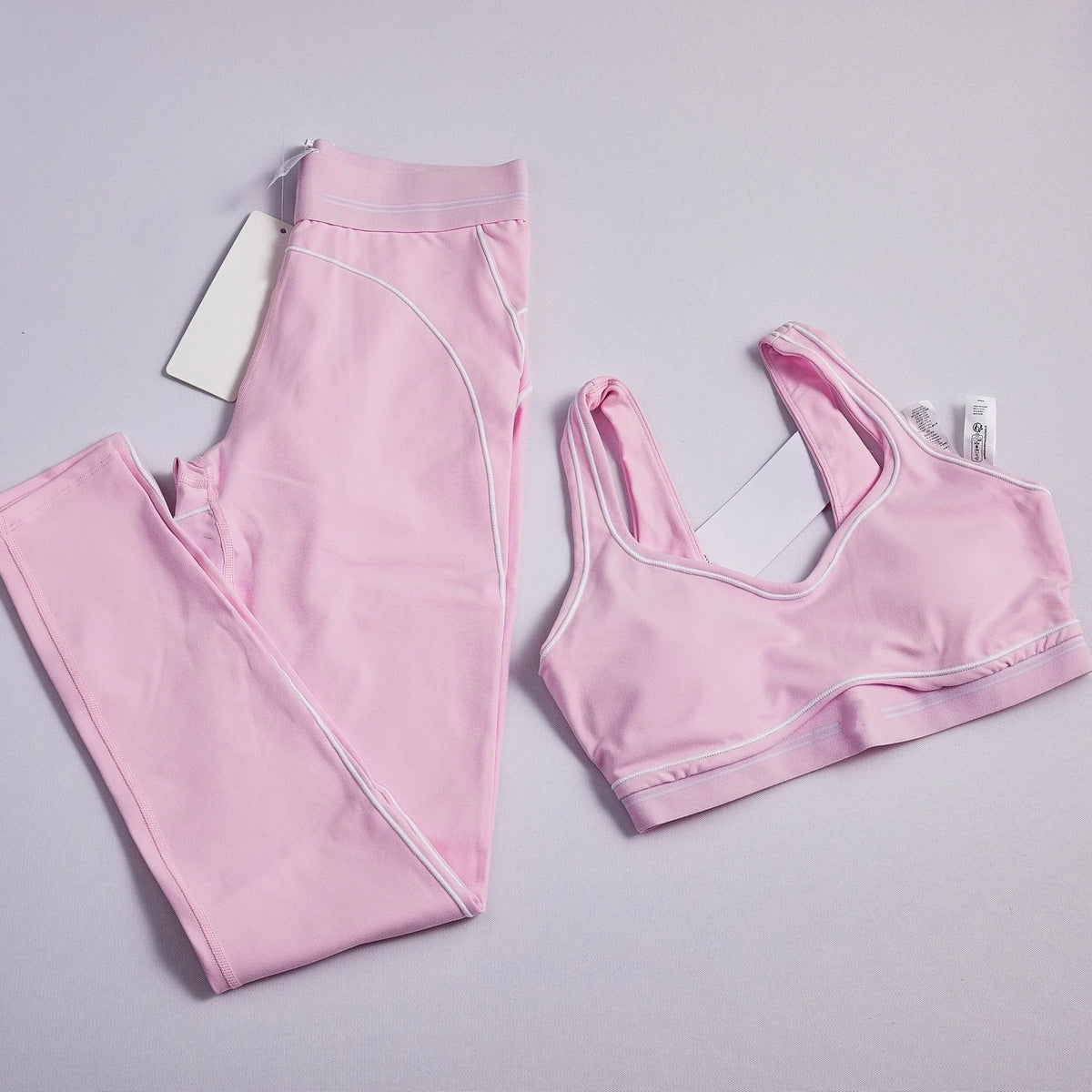 Women's two-piece striped yoga set with leggings and breathable crop top for workouts and running