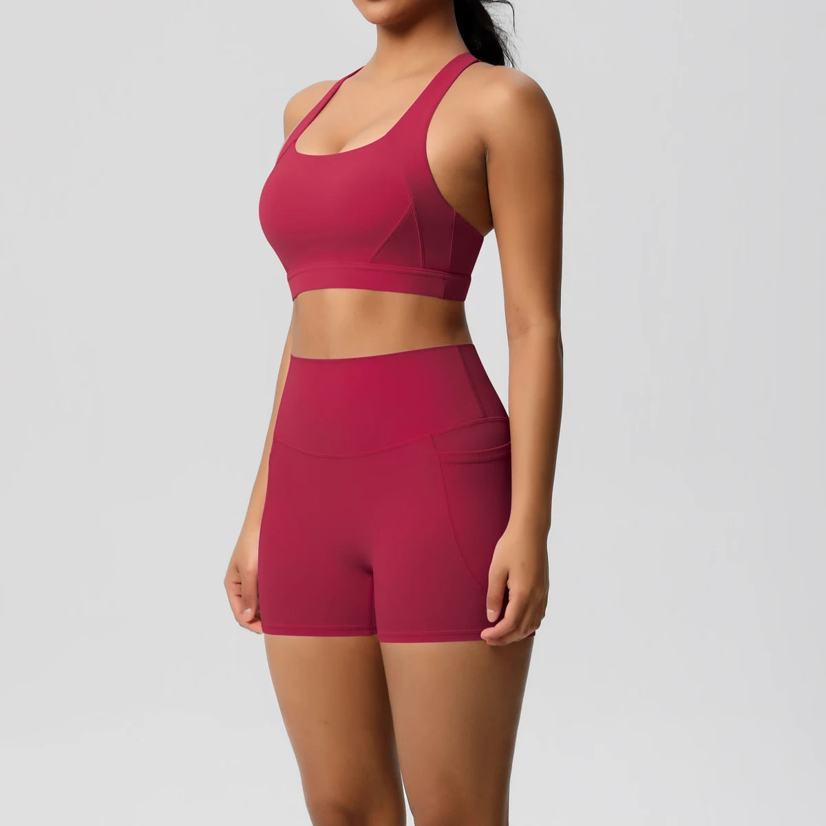 Fitness sportswear set for women featuring pocketed gym clothes, crossover bra, leggings, and sports shorts by The Clothing Company Sydney.