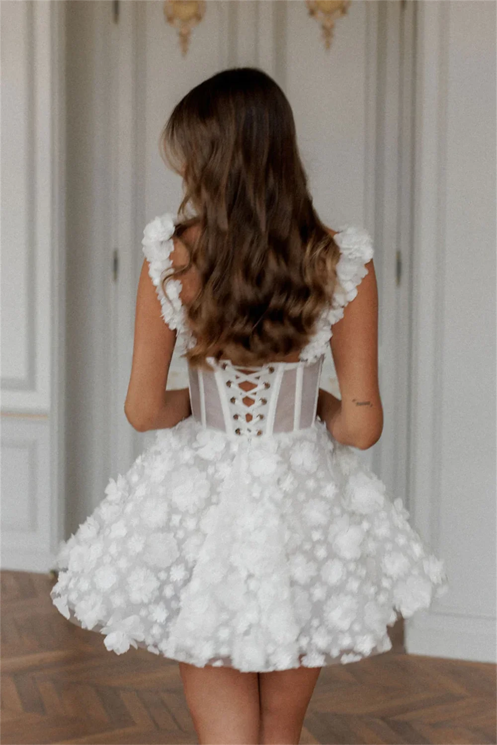 White mini prom dress by The Clothing Company Sydney featuring flower lace embroidery, sleeveless design, and spaghetti straps.