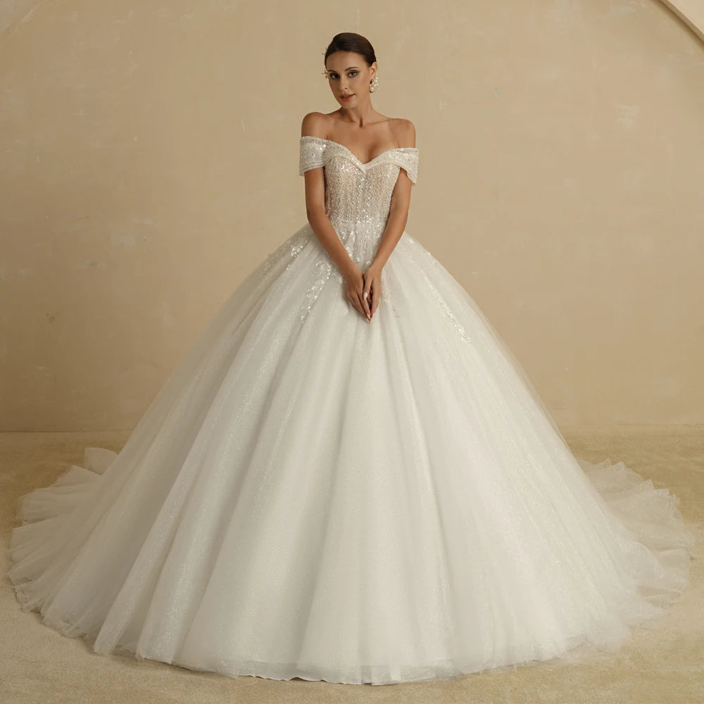 Ivory strapless A-line glitter wedding dress with off-the-shoulder design and bling details, designed for brides by The Clothing Company Sydney