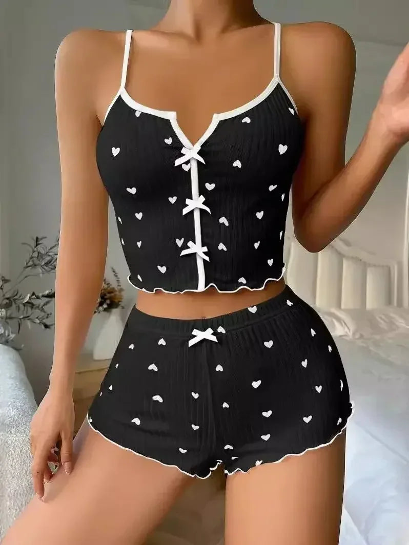 Women’s heart print pyjama set by The Clothing Company Sydney featuring a soft ribbed cami top and matching shorts with frill trim.