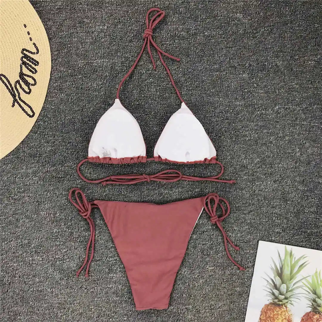Neon pink Brazilian bikini set for women, halter style two-piece swimsuit, from The Clothing Company Sydney, shown on a model