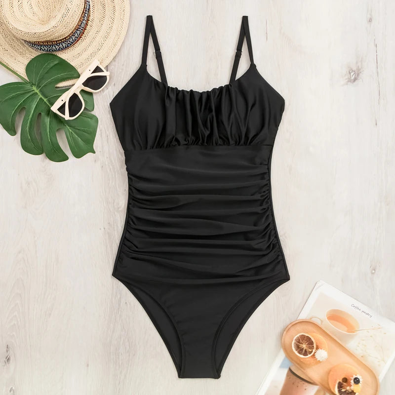 Black one-piece swimsuit by The Clothing Company Sydney featuring a sleek design, perfect for beach or poolside swimming.