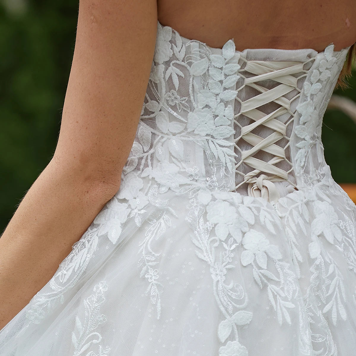 Elegant sleeveless lace wedding dress with deep V-neck and sparkly details, featuring a sweetheart neckline by The Clothing Company Sydney.