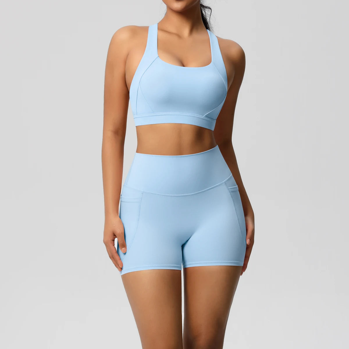 Women’s fitness sportswear set with crossover bra, pocketed gym shorts, and leggings from The Clothing Company Sydney.
