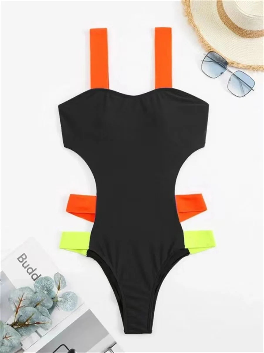 Black contrast one-piece swimsuit with neon straps and hollow out back, featuring patchwork design, by The Clothing Company Sydney.