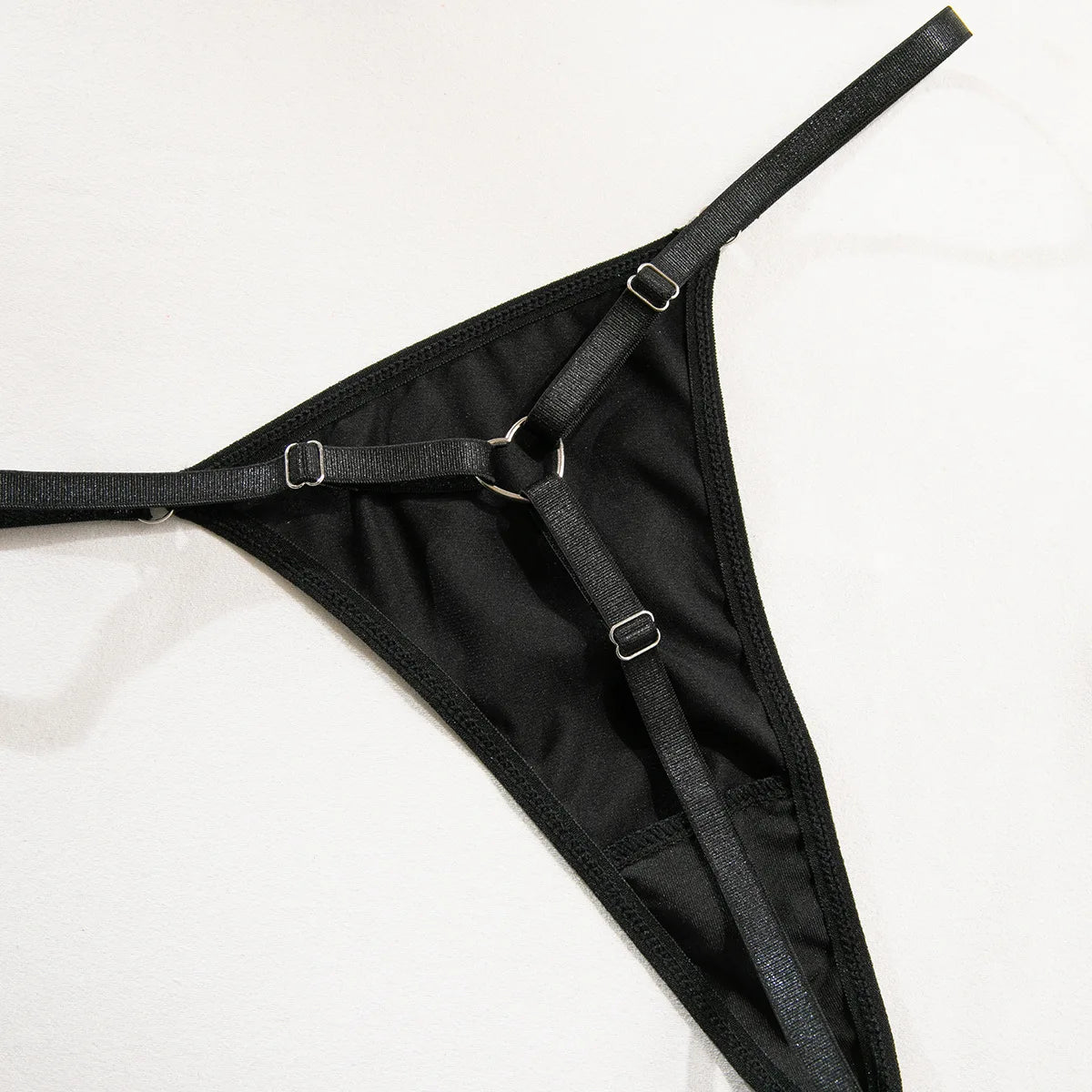 Lace lingerie set including halter bra, g-string, heart-shaped details, and garter belt from The Clothing Company Sydney.