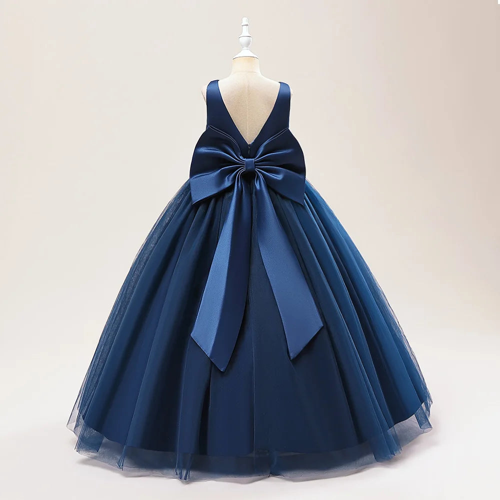 Girls white bridesmaid and prom gown with a large bow, formal evening dress for kids by The Clothing Company Sydney.