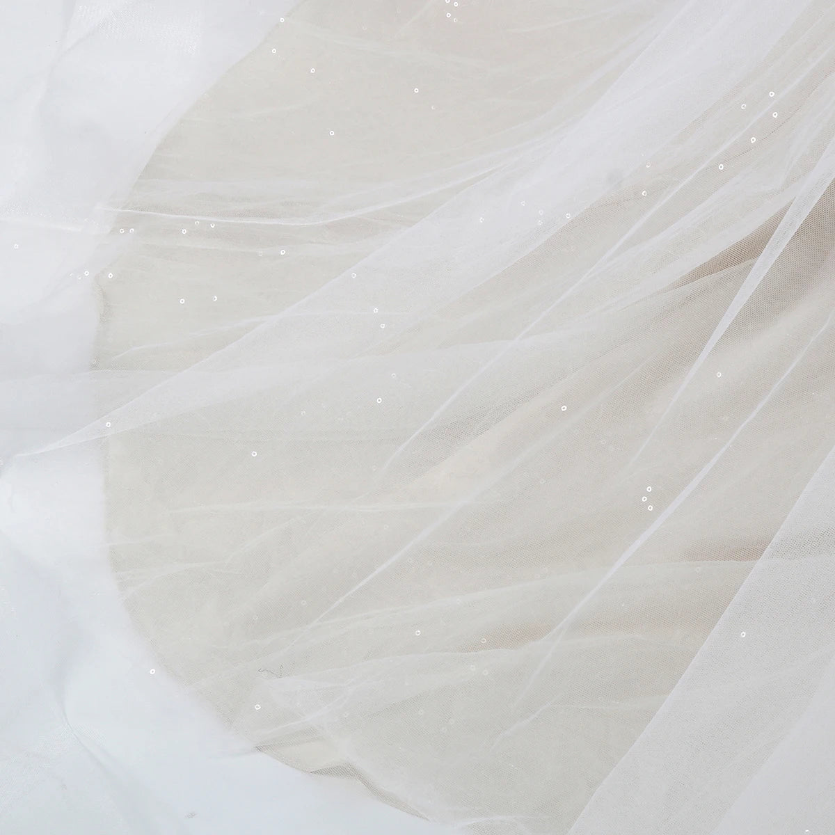 Elegant sleeveless lace wedding dress with deep V-neck and sparkly embellishments, designed by The Clothing Company Sydney.