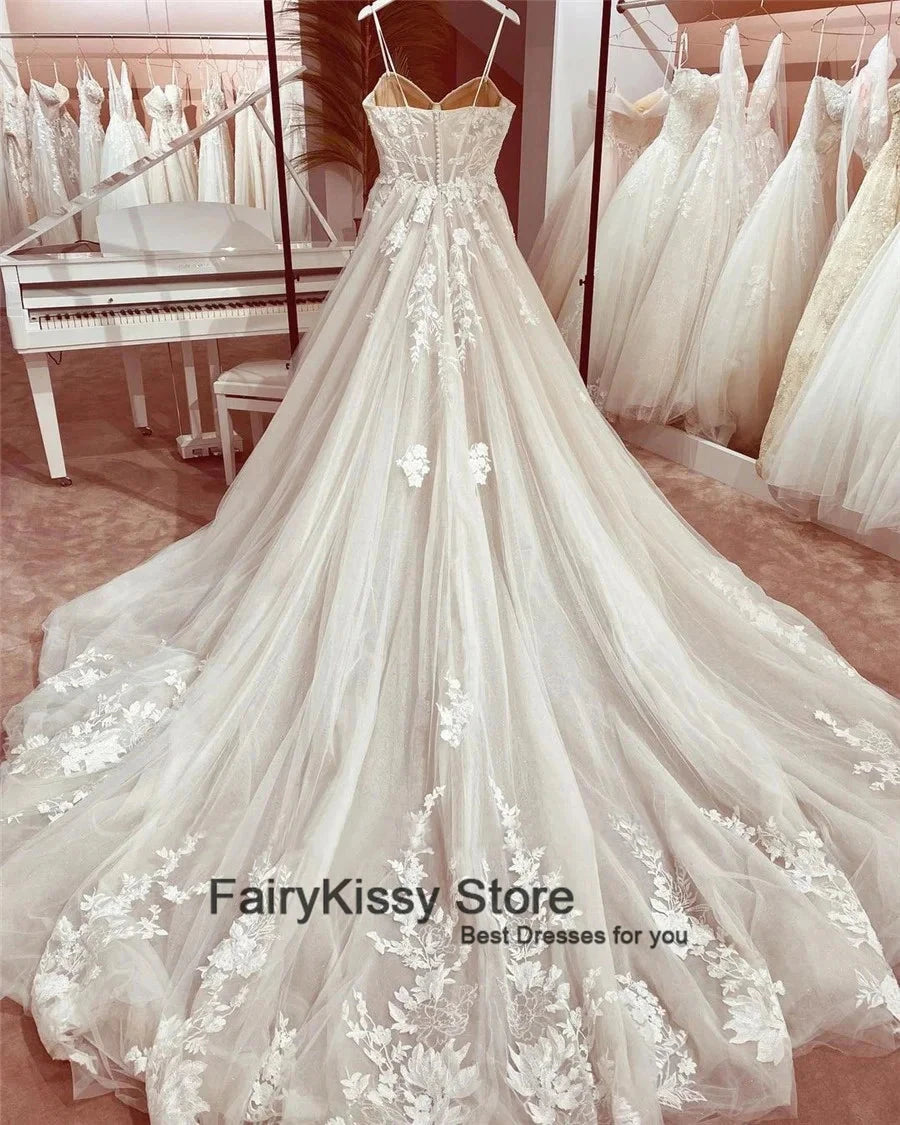 See-through mesh backless wedding dress with spaghetti straps, lace details, and exposed boning by The Clothing Company Sydney.