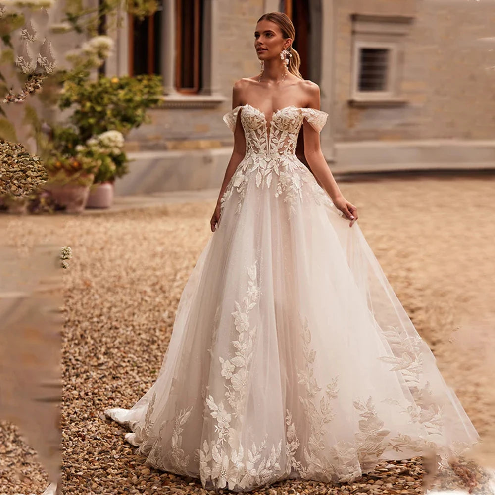 Off-the-shoulder wedding dress with 3D flower lace appliqué, A-line silhouette, custom-made bridal gown by The Clothing Company Sydney.