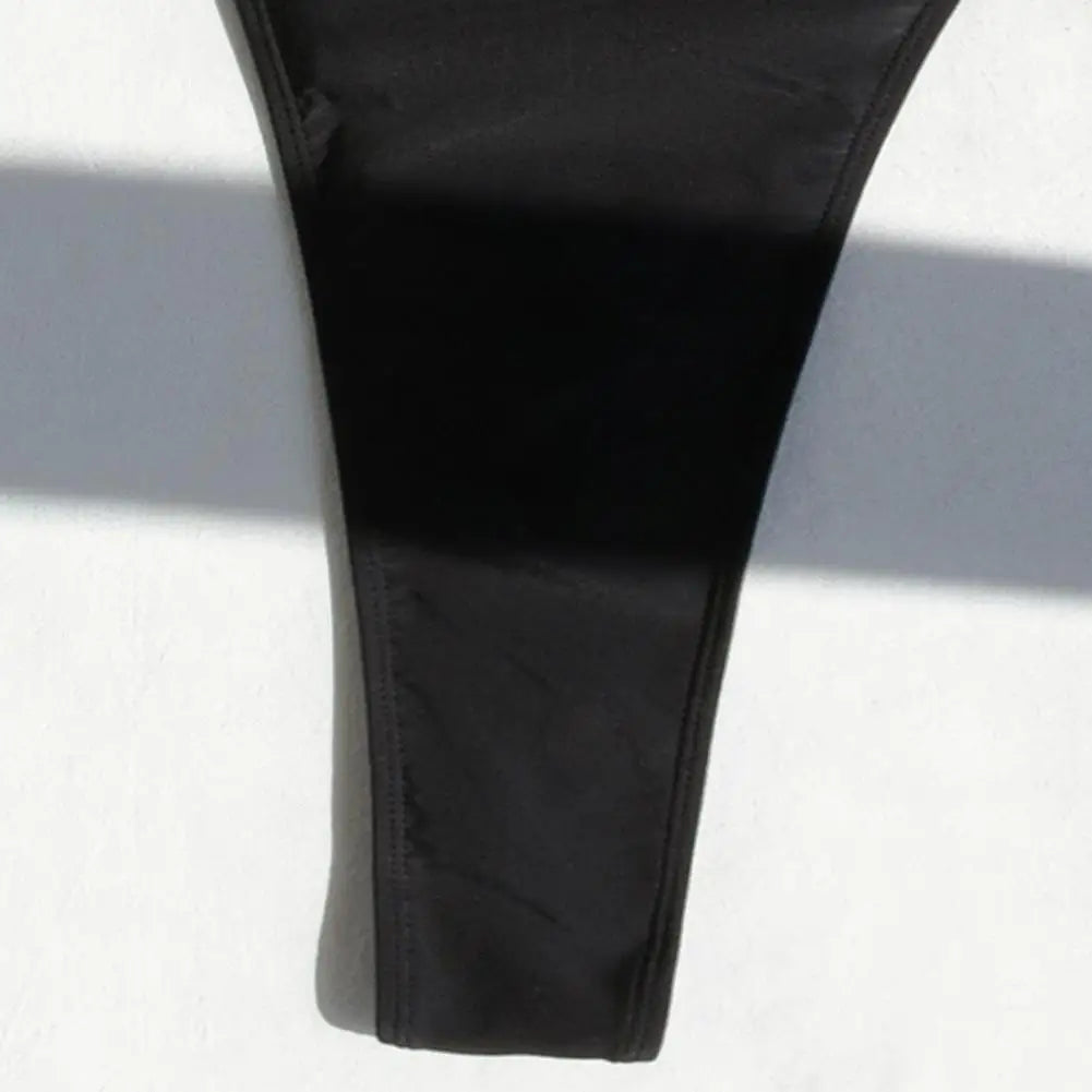 Backless micro thong one-piece swimsuit for women by The Clothing Company Sydney, featuring a sleek, minimal design for beachwear.