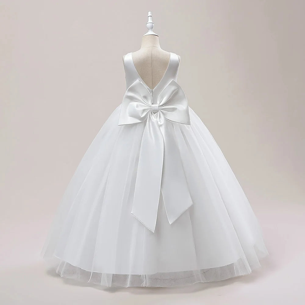 Girls white bridesmaid and prom gown with a large bow, formal evening dress for weddings, parties, and communions by The Clothing Company Sydney.