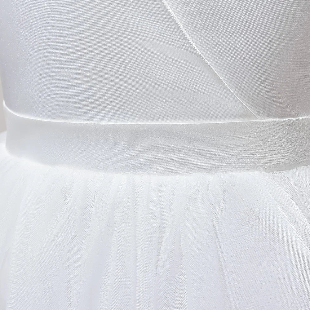 Girls long white bridesmaid wedding prom gown with a large bow, formal evening dress for kids by The Clothing Company Sydney.