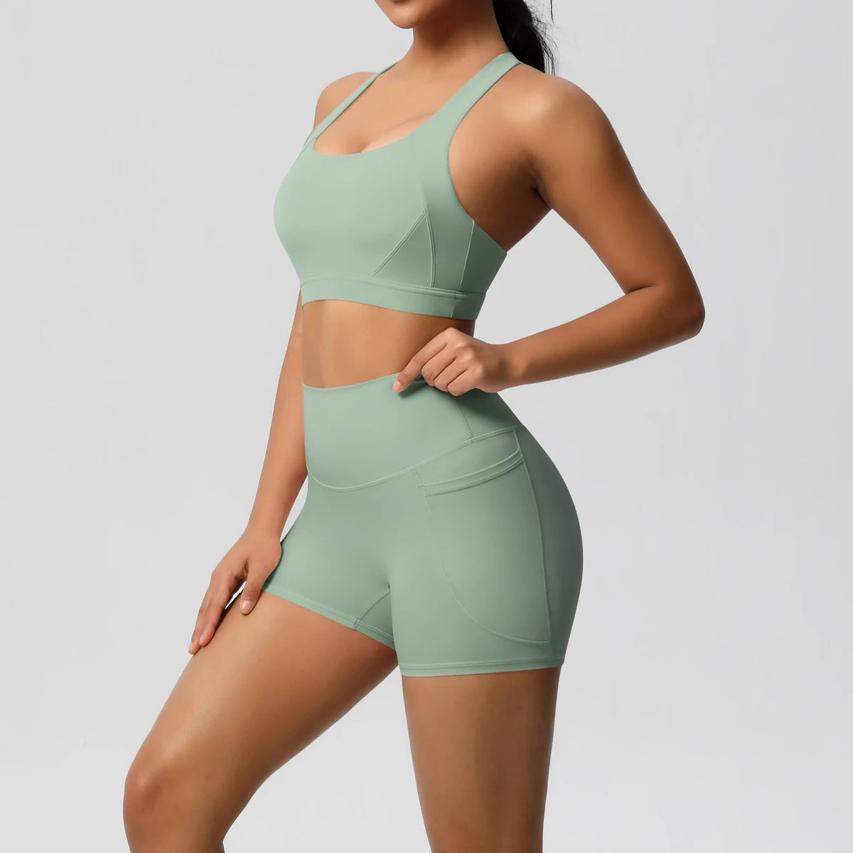 Women's fitness yoga set with crossover bra, pocketed gym shorts, and leggings from The Clothing Company Sydney, ideal for workout sessions.