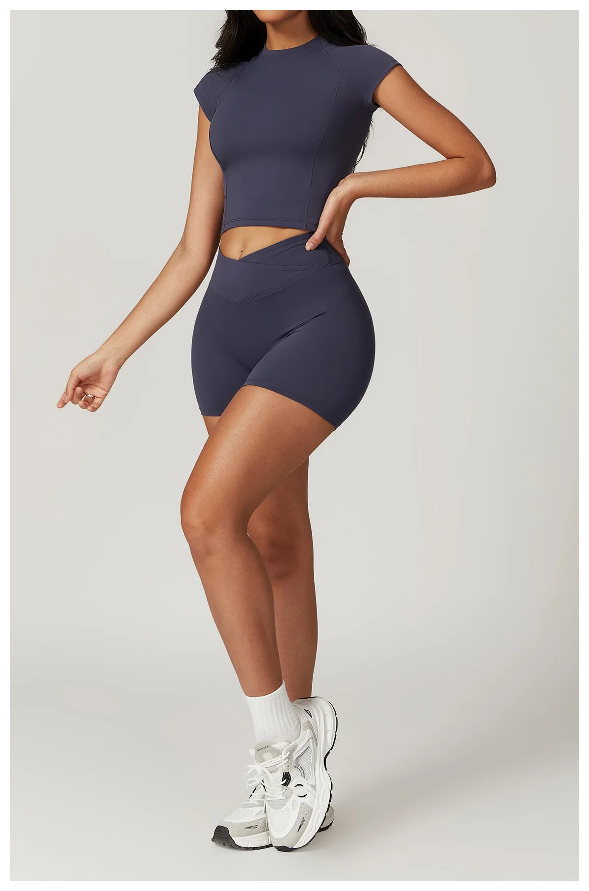 Two-piece women's fitness gym outfit with short sleeve crop top, sports bra, and leggings from The Clothing Company Sydney.