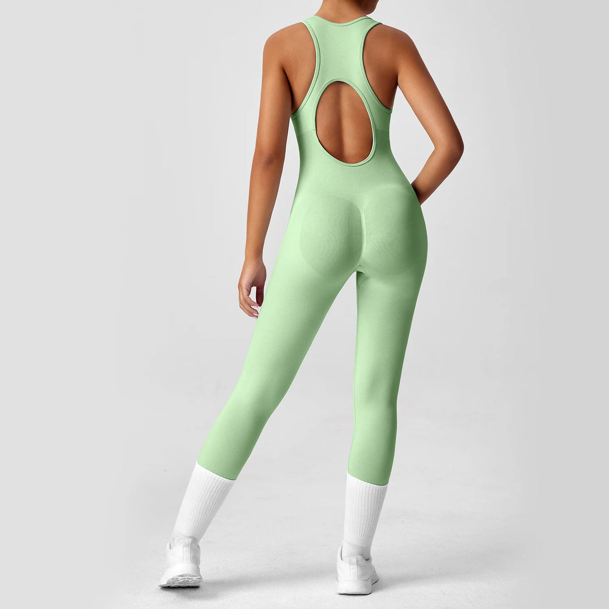 Seamless peach-colored women's fitness bodysuit with V-back, designed for yoga and workout activities by The Clothing Company Sydney.