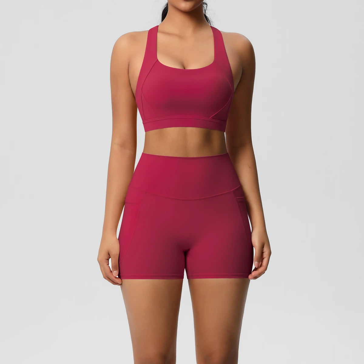 The Clothing Company Sydney women's 2-piece sportswear yoga set with pocketed gym shorts, crossover bra, and leggings for active fitness.