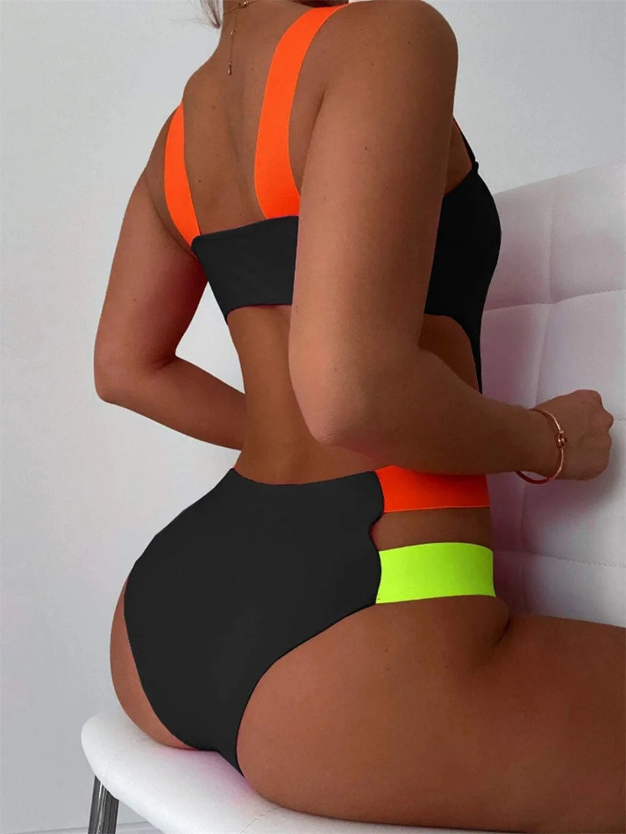 Black contrast one-piece swimsuit with neon straps, hollow out backless design, patchwork details, perfect for summer beachwear.