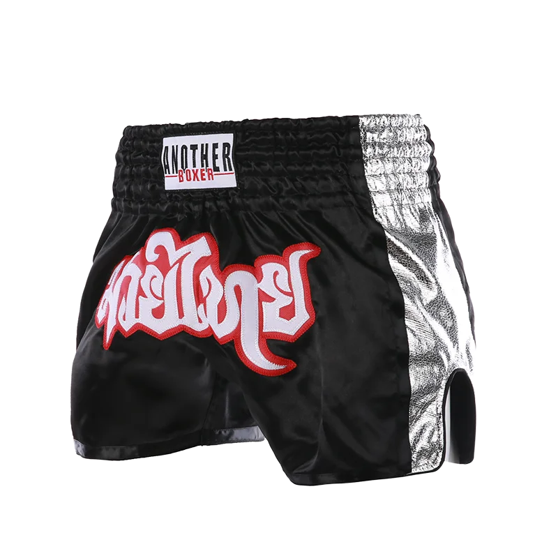 Embroidered Muay Thai boxing shorts with intricate design and The Clothing Company Sydney branding, displayed on a white background.