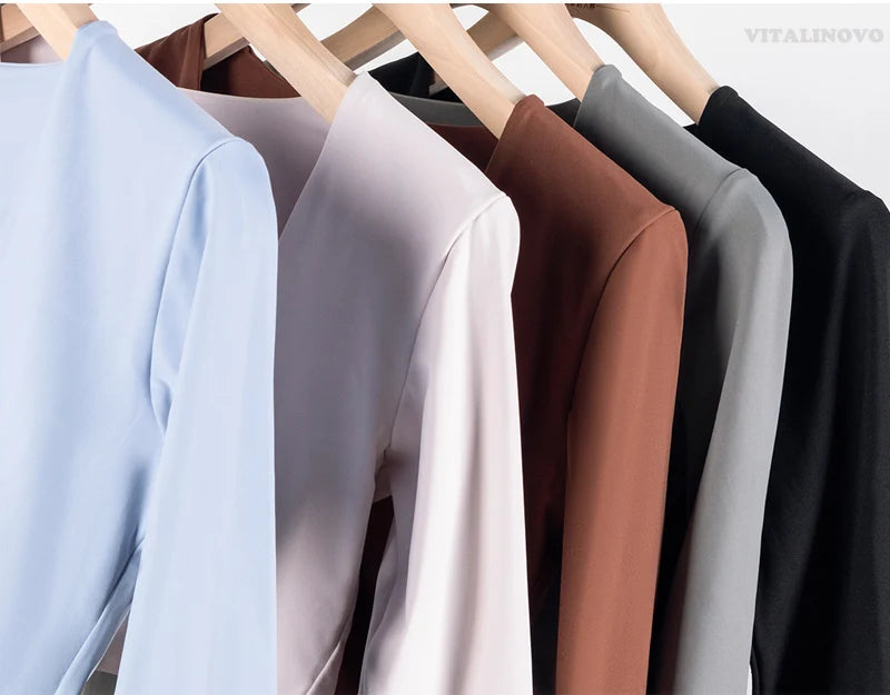 Long sleeve fitness crop top by The Clothing Company Sydney featuring twist design, deep V neckline, quick-dry fabric, padded for workouts.