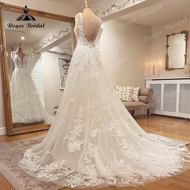 Blush pink sleeveless wedding dress with V-neck, lace applique, backless design, A-line silhouette from The Clothing Company Sydney.