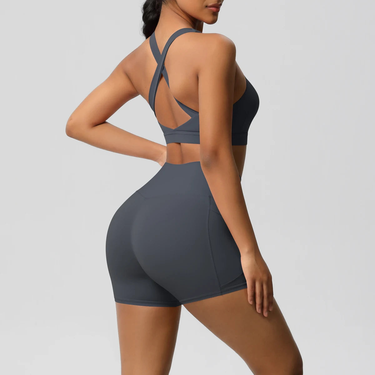 Women’s 2-piece sportswear set with pocketed gym shorts, crossover bra, and leggings from The Clothing Company Sydney for fitness.